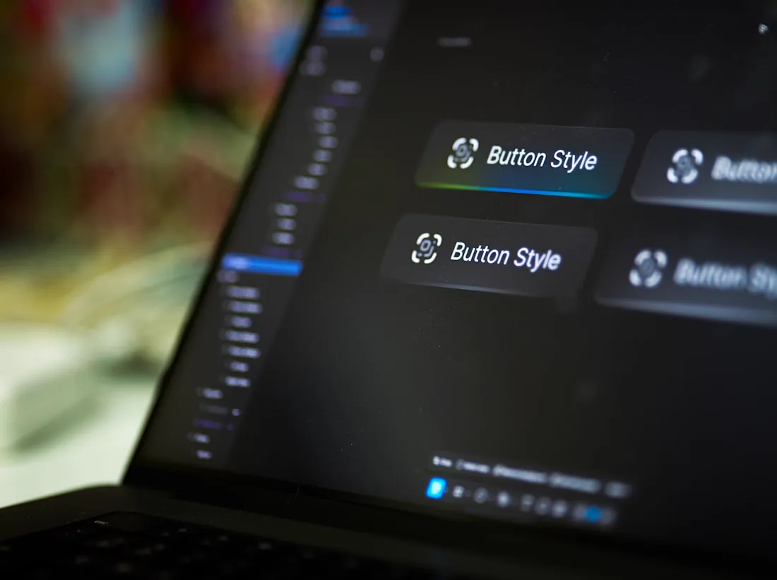 Button component styles laid out in a design tool on a laptop