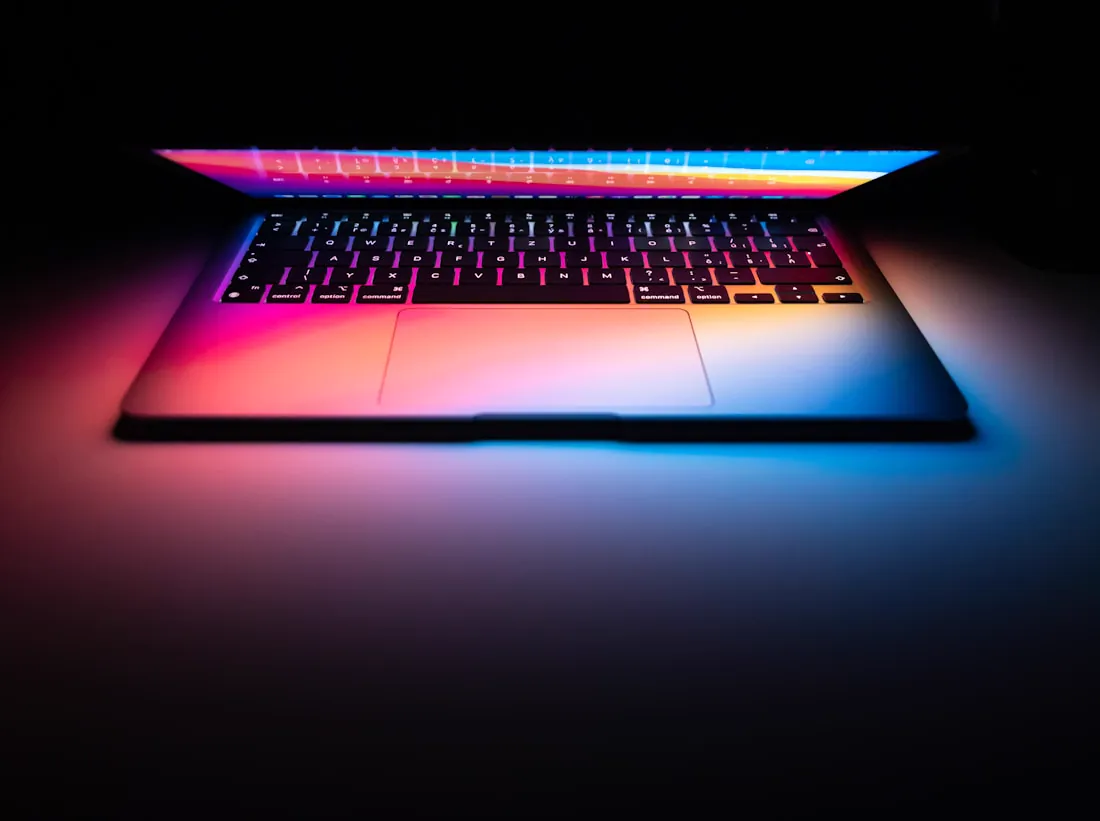 An online store open on a laptop glowing in a darkened room
